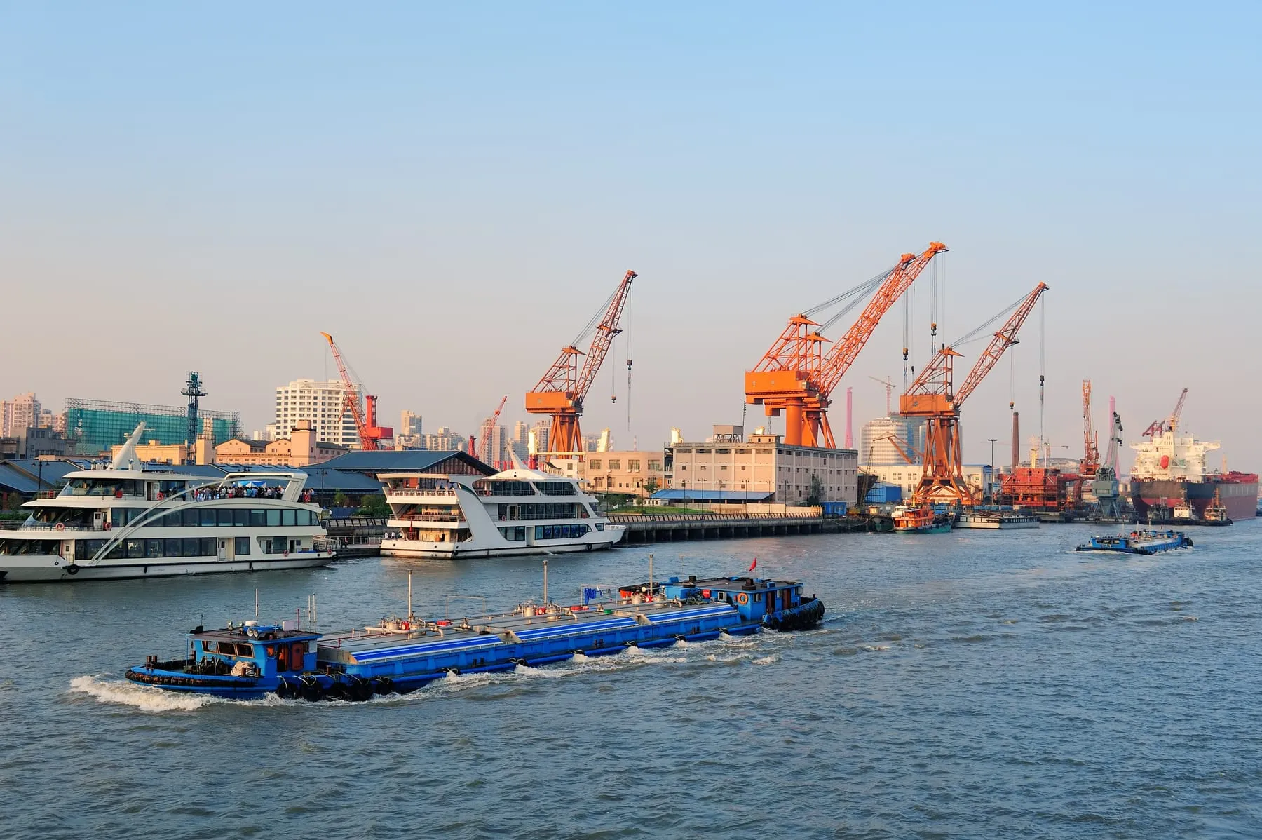 Boat huangpu river with shanghai urban architecture cargo crane