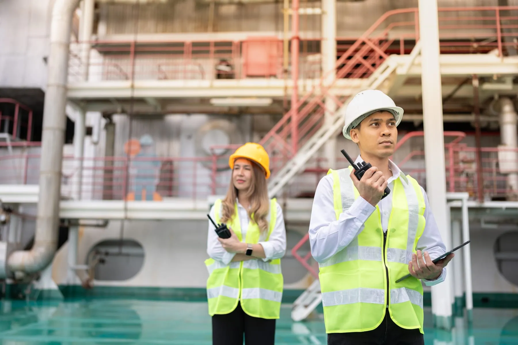 Asian male female engineers are responsible developing energy technologies steam wind power plants influencing business outcomes growth large industries