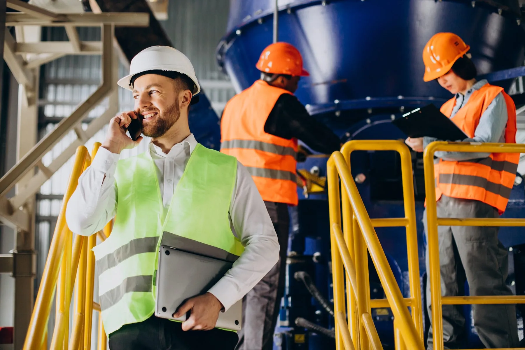 Inspector factory talking phone while others are working