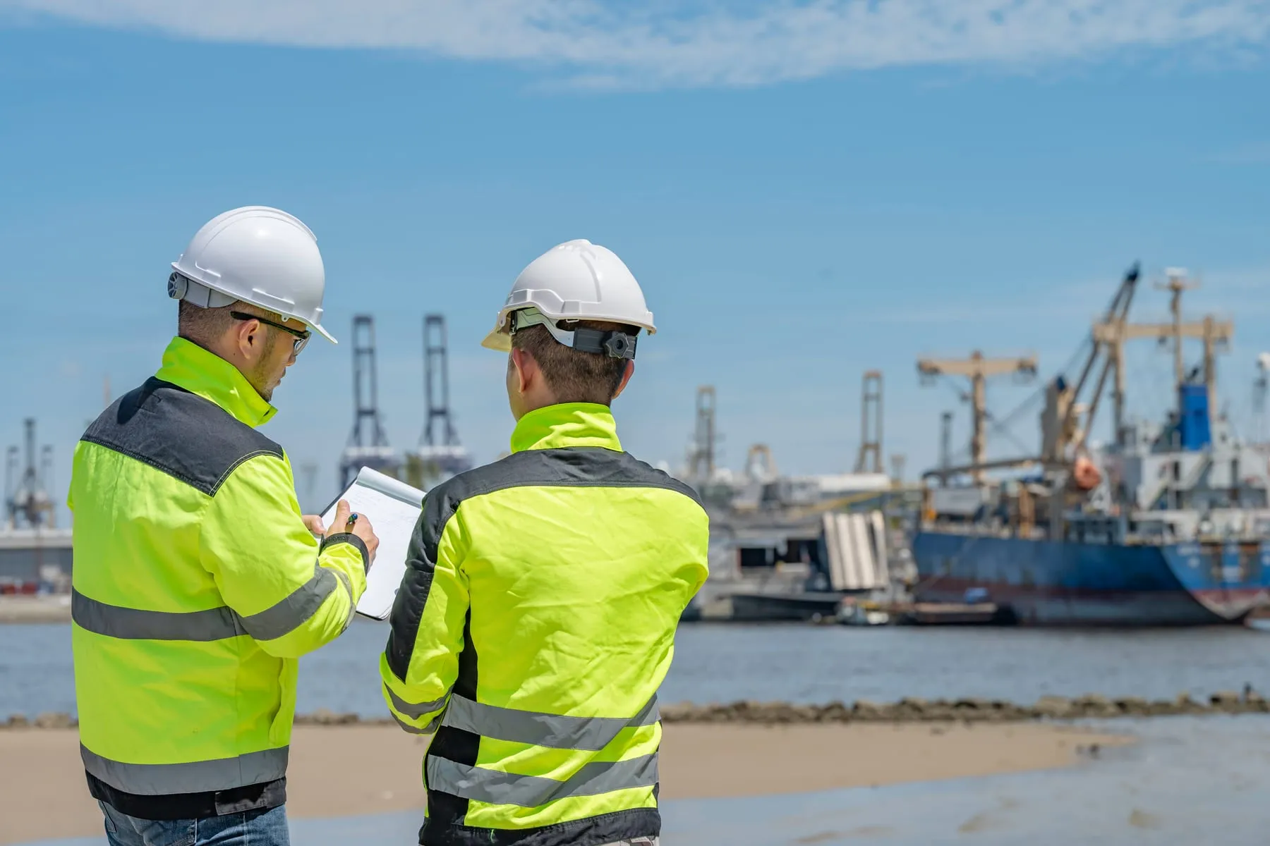 Engineer works busy shipping port inspecting containers managing logistics operations ensuring smooth import export processes with safety efficiency global trade